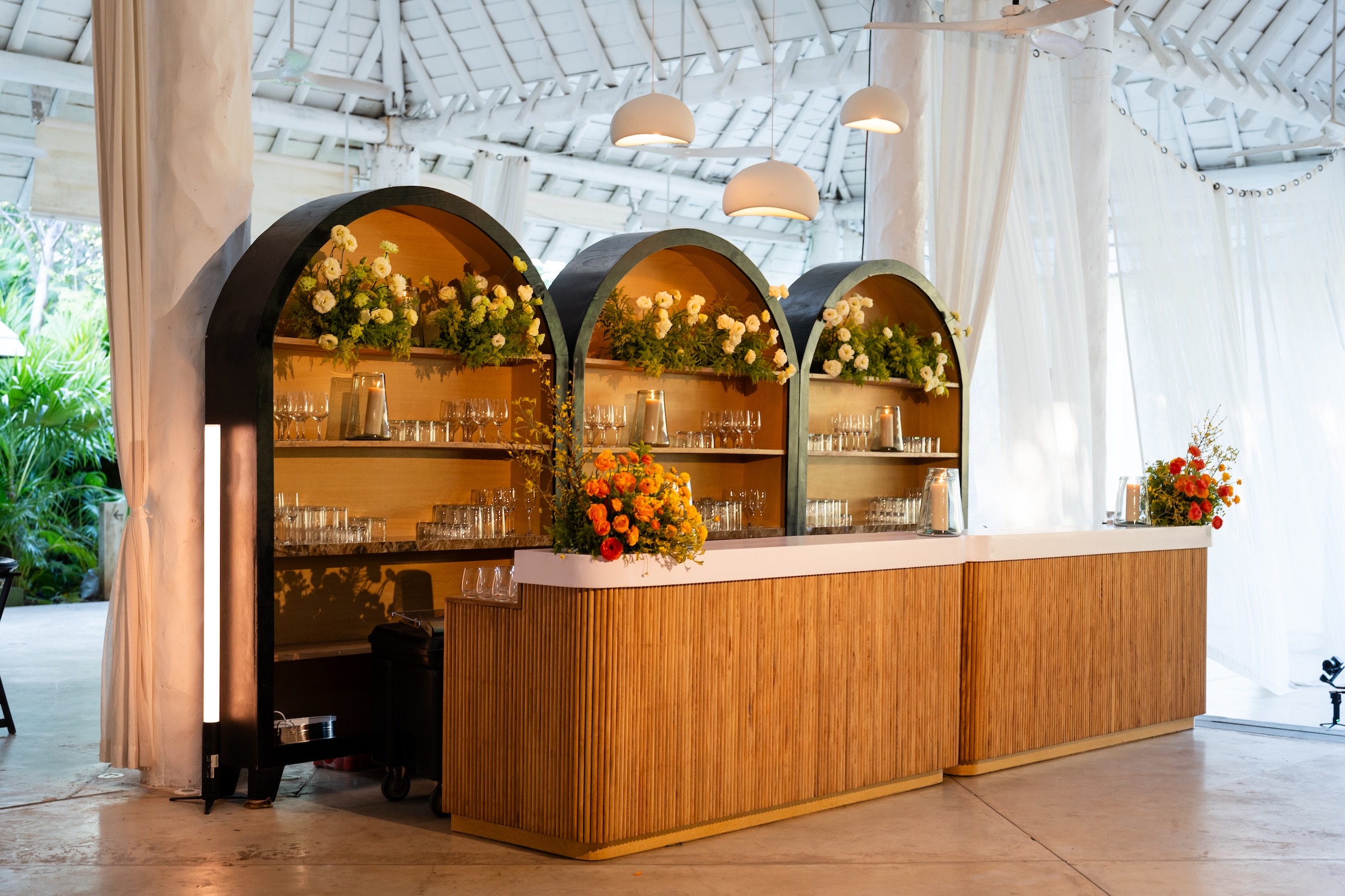 Canteiro custom bar installation with floral arches