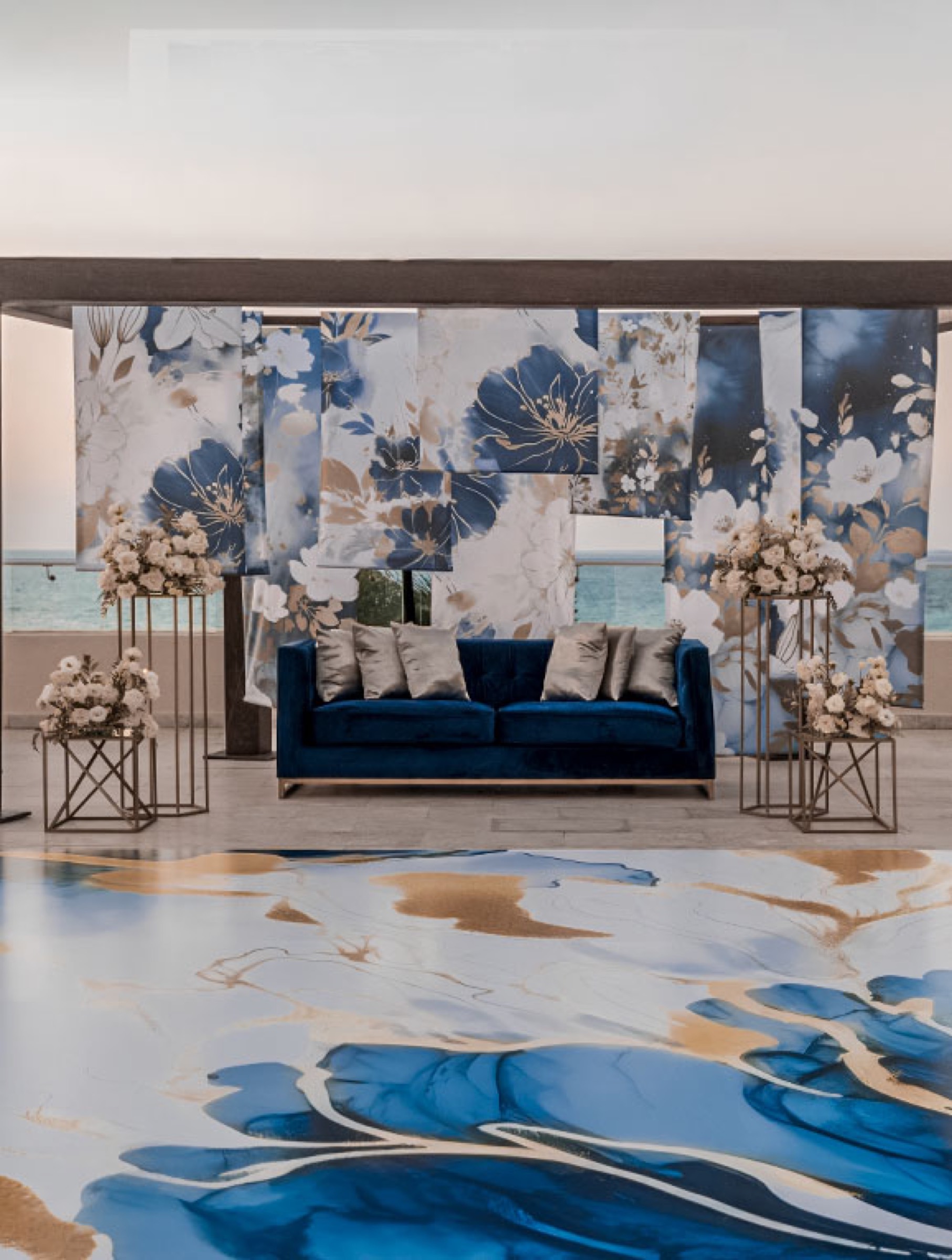 Custom blue and gold dance floor with patterned floral backdrop over the ocean